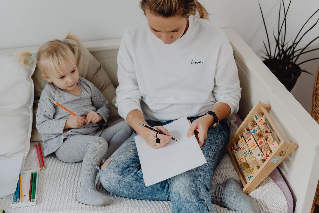 A mother teaching her young child at home
